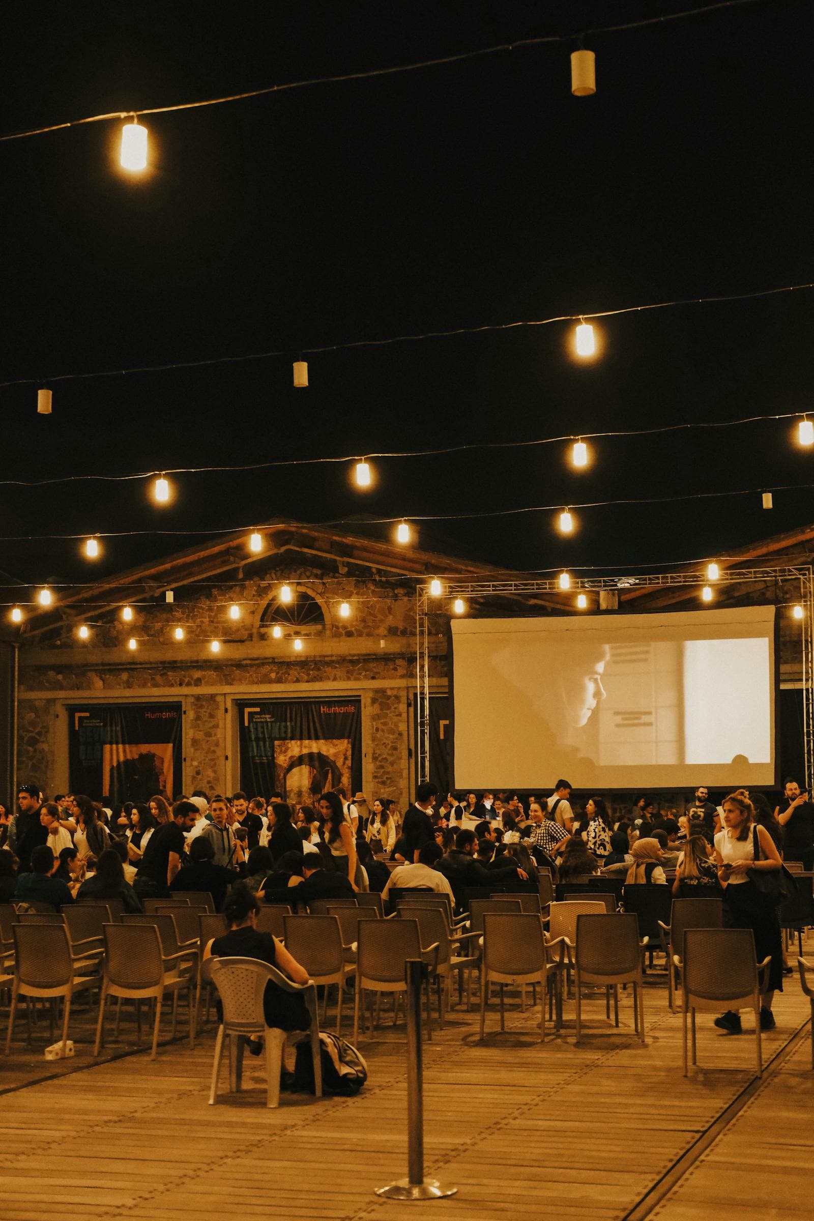 Outdoor corporate evening event with string lights