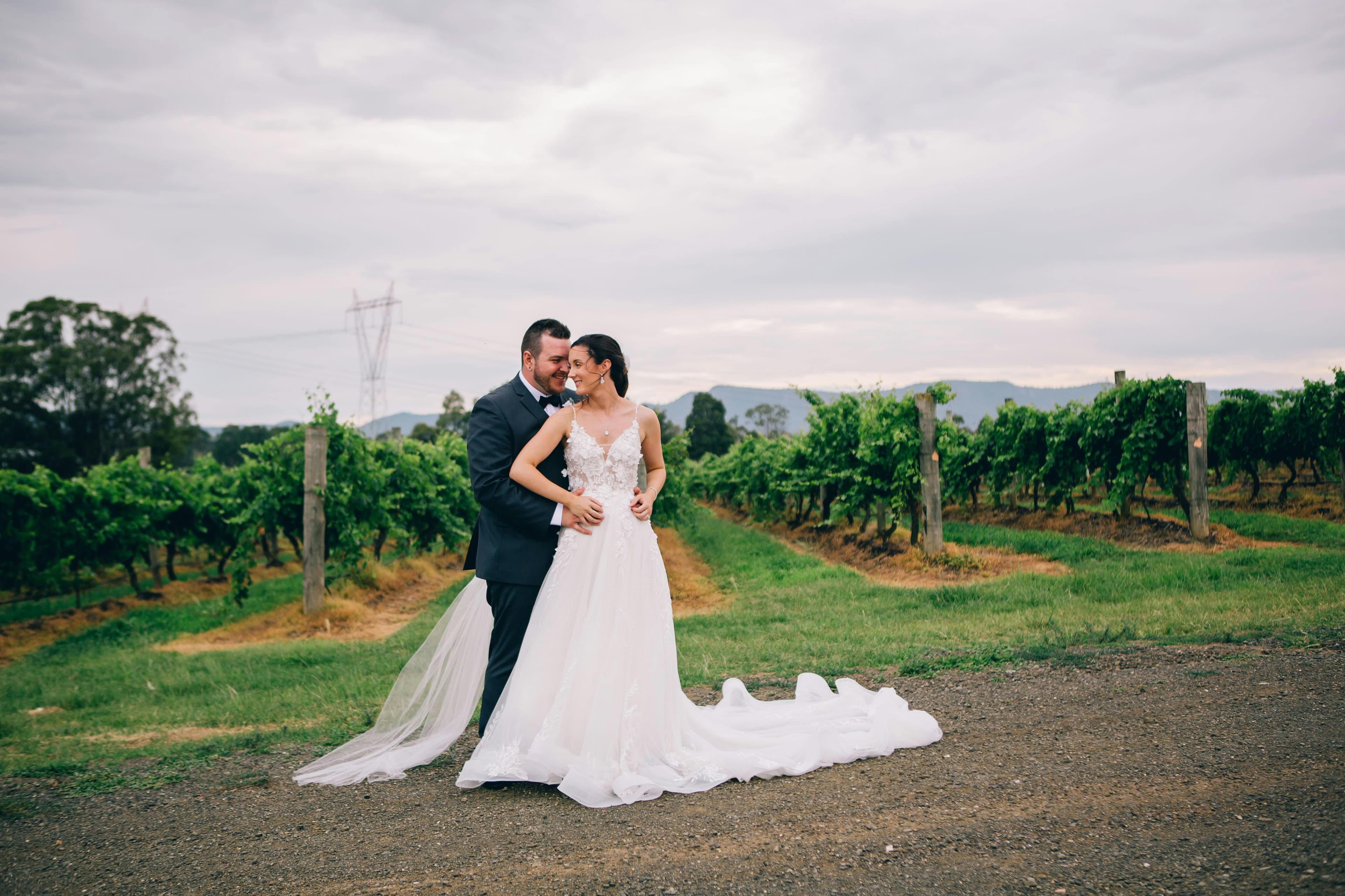 Newlywed couple at sunset in a vineyard